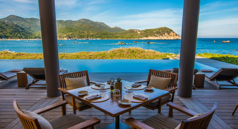 Luxury beachfront dining experience overlooking turquoise waters in Vietnam, curated by a Vietnam DMC