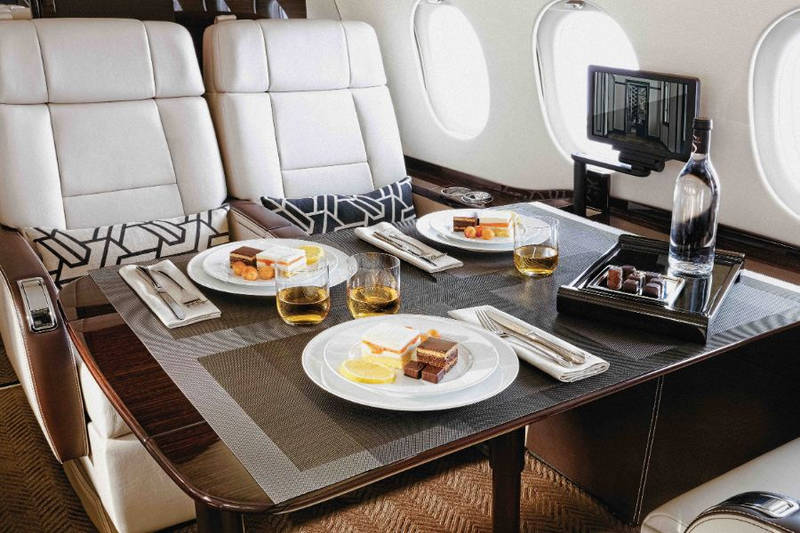 Luxury private jet interior with fine dining setup for VIP travelers in Vietnam