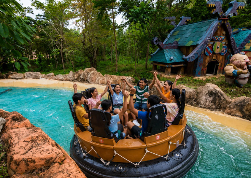 Family cheering together on a log flume ride at VinWonders theme park