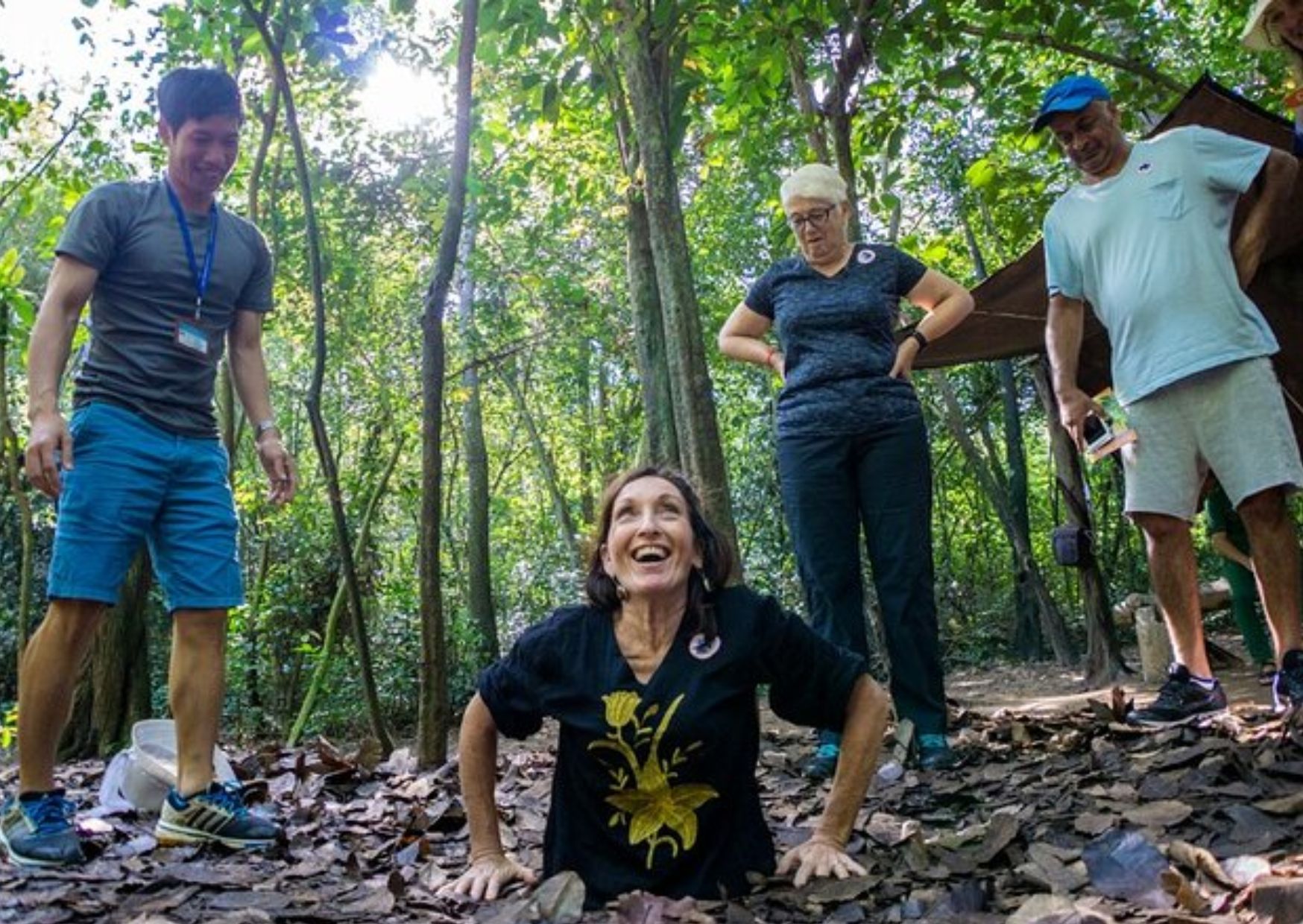 Family group standing at the Cu Chi Tunnels historical site