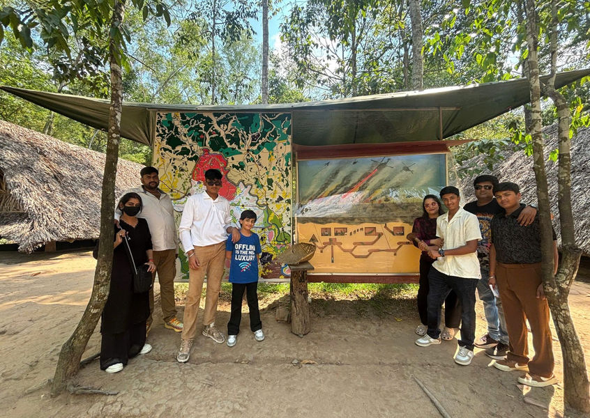 Family group standing at the Cu Chi Tunnels historical site