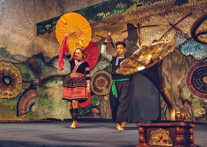 Hmong ethnic dancers in traditional costume performing on stage Sapa Vietnam