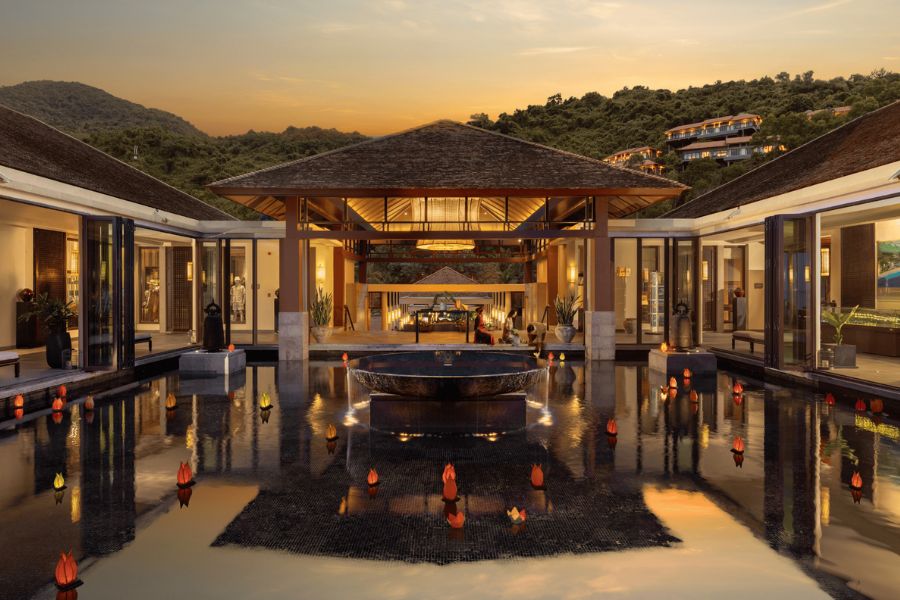 Resort courtyard with reflecting pool lit at dusk