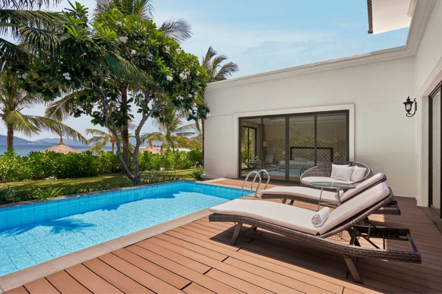Private pool terrace with lounge chairs and palm trees