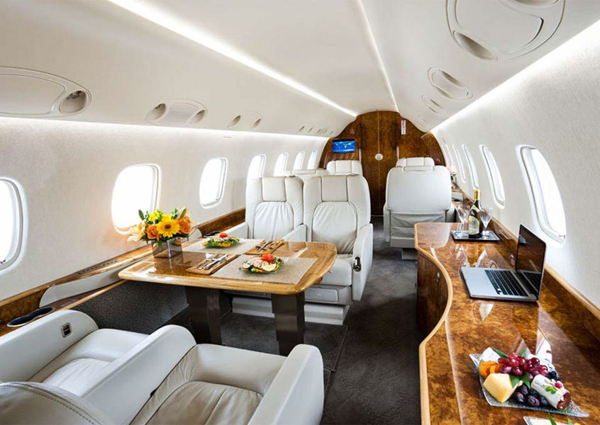 Luxury private jet cabin interior with dining setup